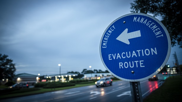 Stormy skies and an evacuation route sign
