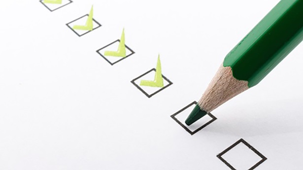 Checklist with green check marks and a green pencil