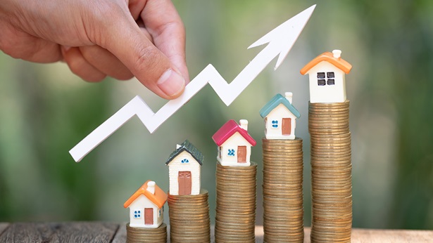 Tiny houses on ascending stacks of pennies