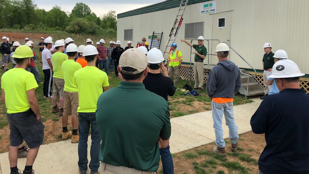 Man speaking to a group of construction workers