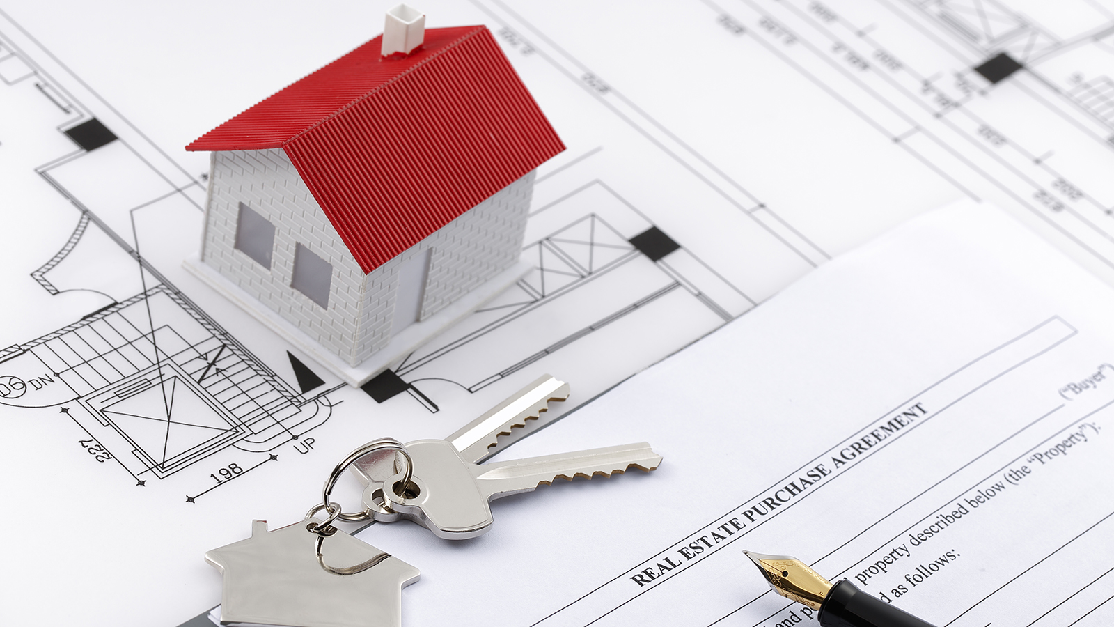 Tiny house and keys on papers