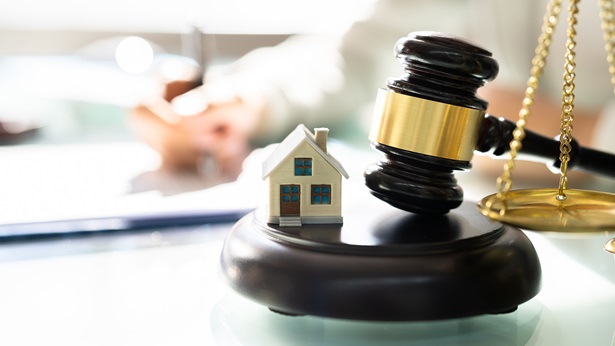 Tiny house on a gavel and balance next to it