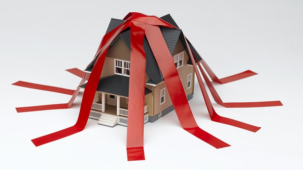 Animated house with red tape all over it