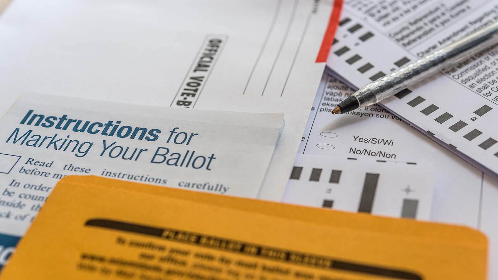 Ballot papers and a pen