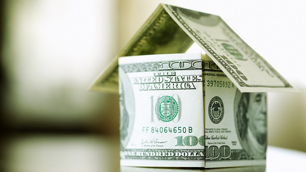 Hundred dollar bills in the shape of a house