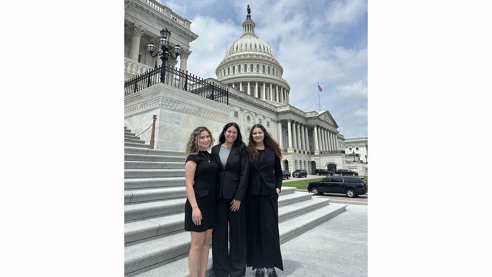three interns standing in front of capitol