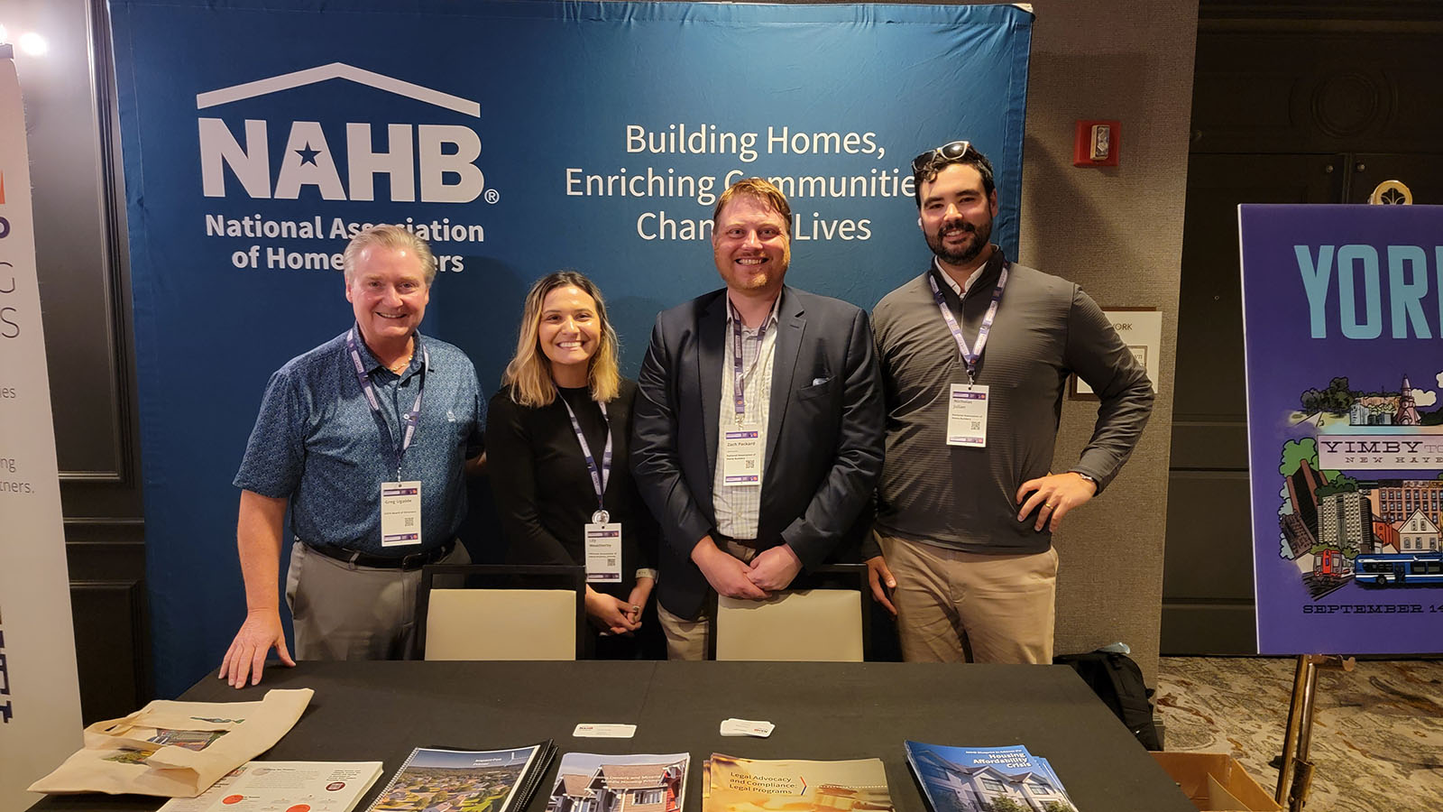 three individuals standing behind the booth