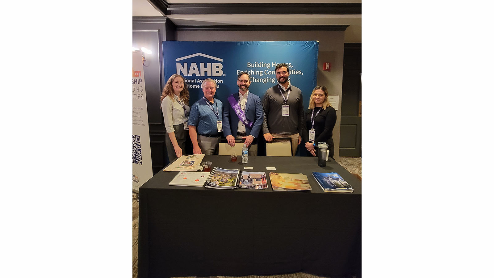 group of individuals standing behind a booth