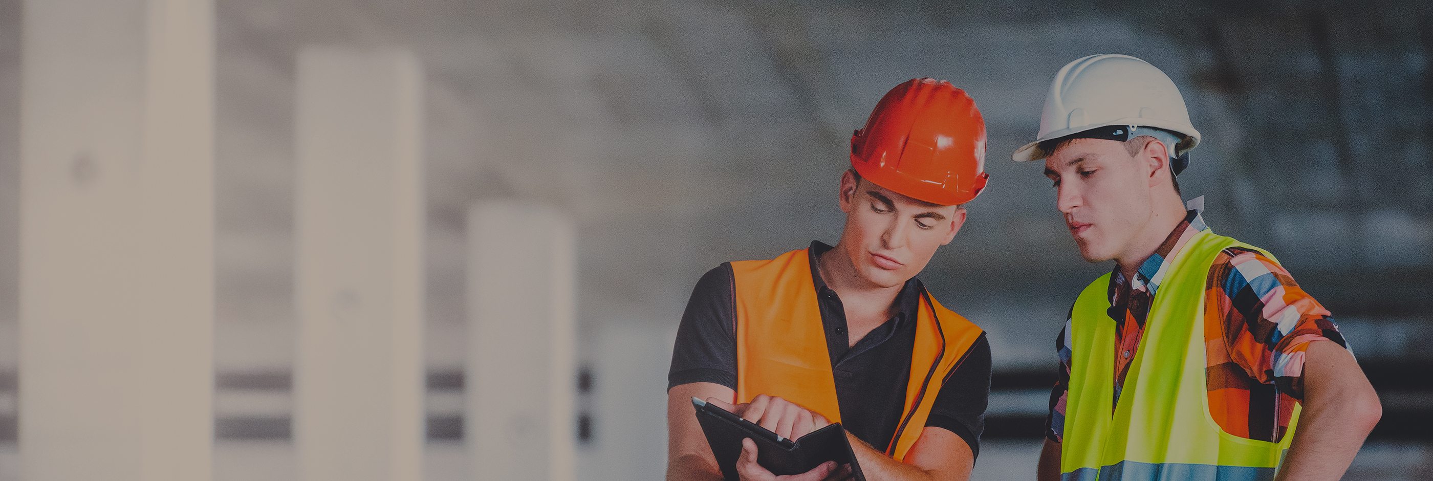 Two young building architects at construction site