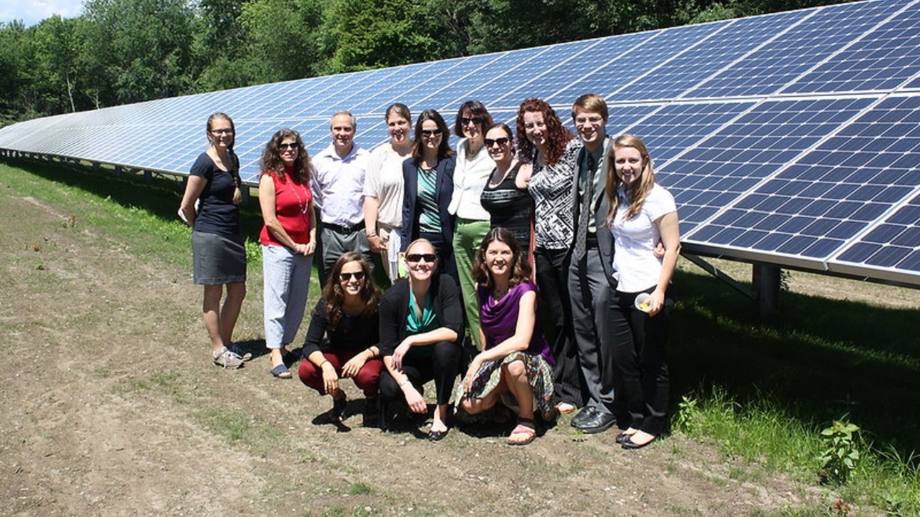 A group of people at the Harvard solar Community garden