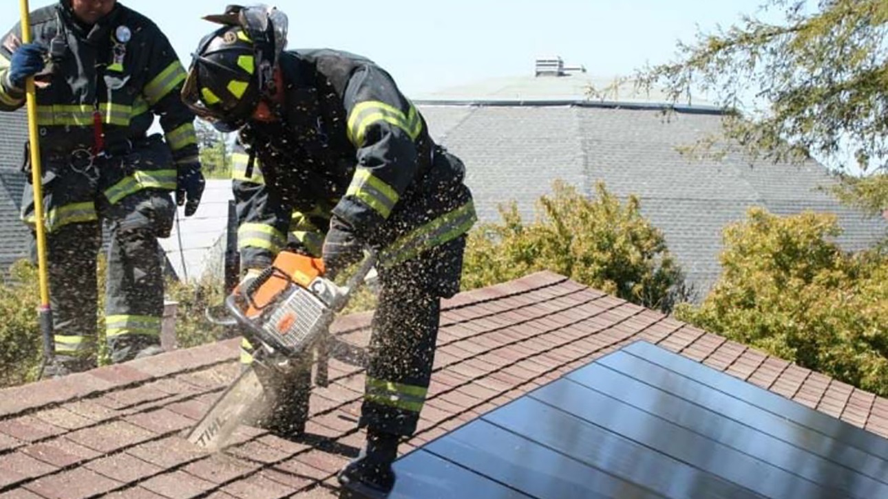 Firefighter on solar panel roof