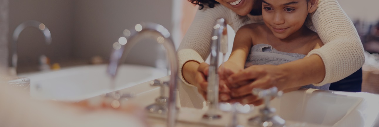 Cropped shot of a mother and daughter washing their hands at the bathroom sink