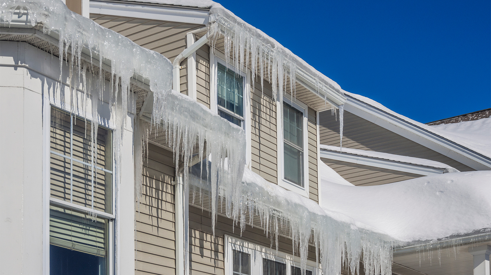 Large ice dams forming on a home's gutters