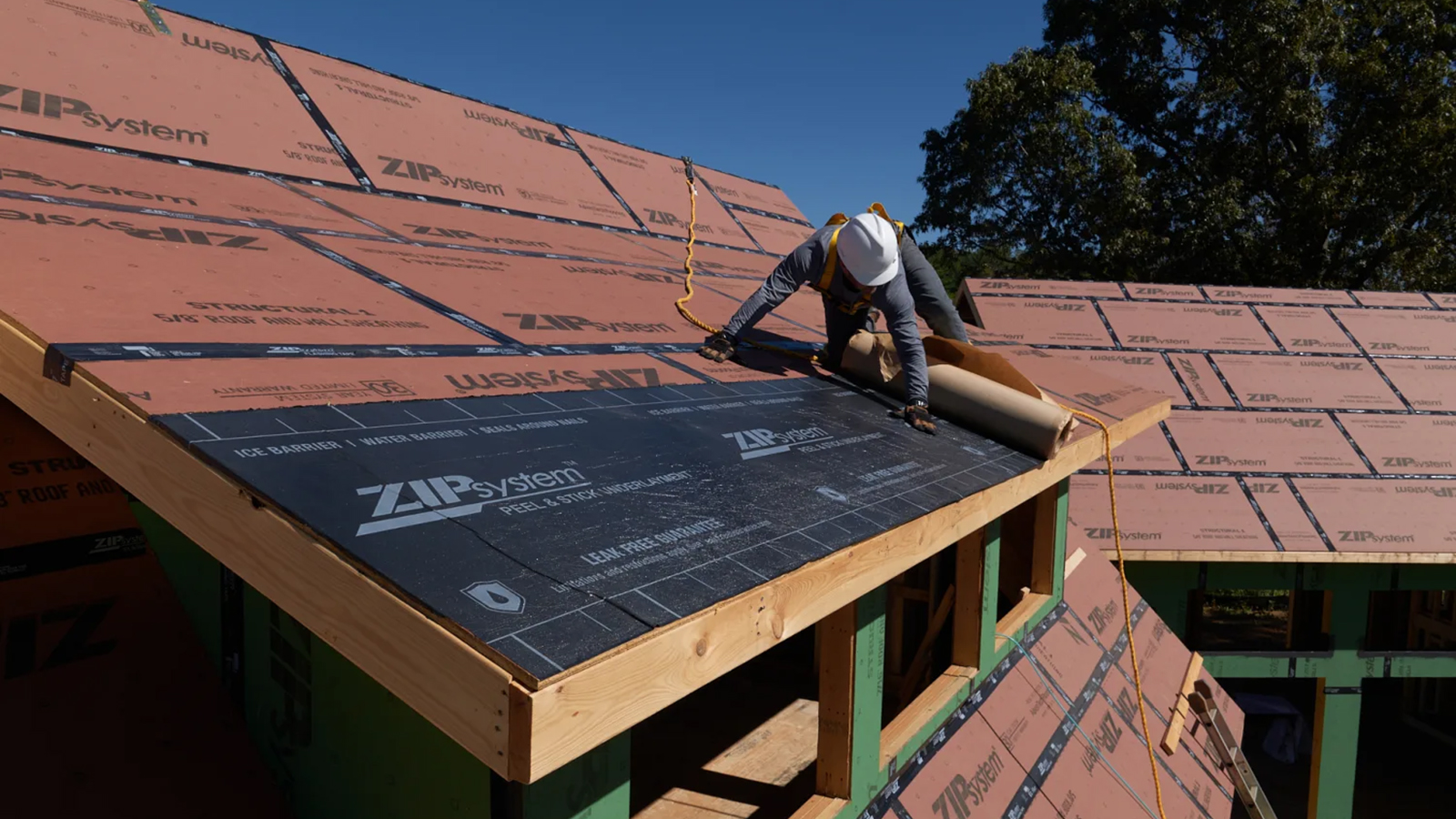 Sealing paper on a roof being installed