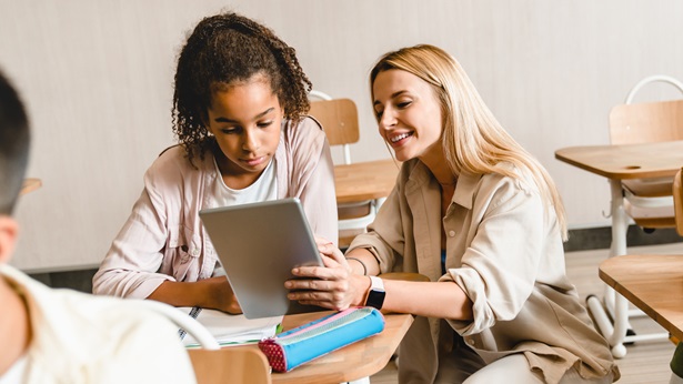Woman showing information from an ipad to another woman