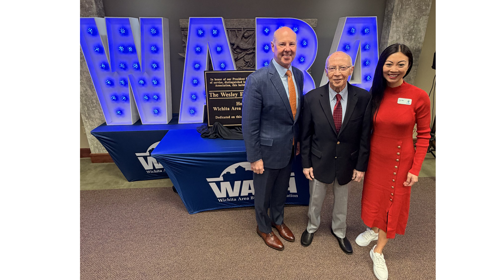 individuals standing in front of a sign