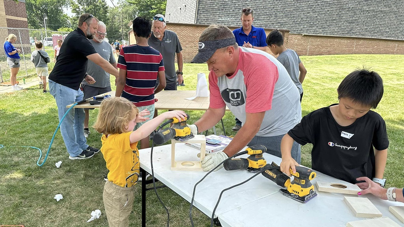 kids and adults working on construction project