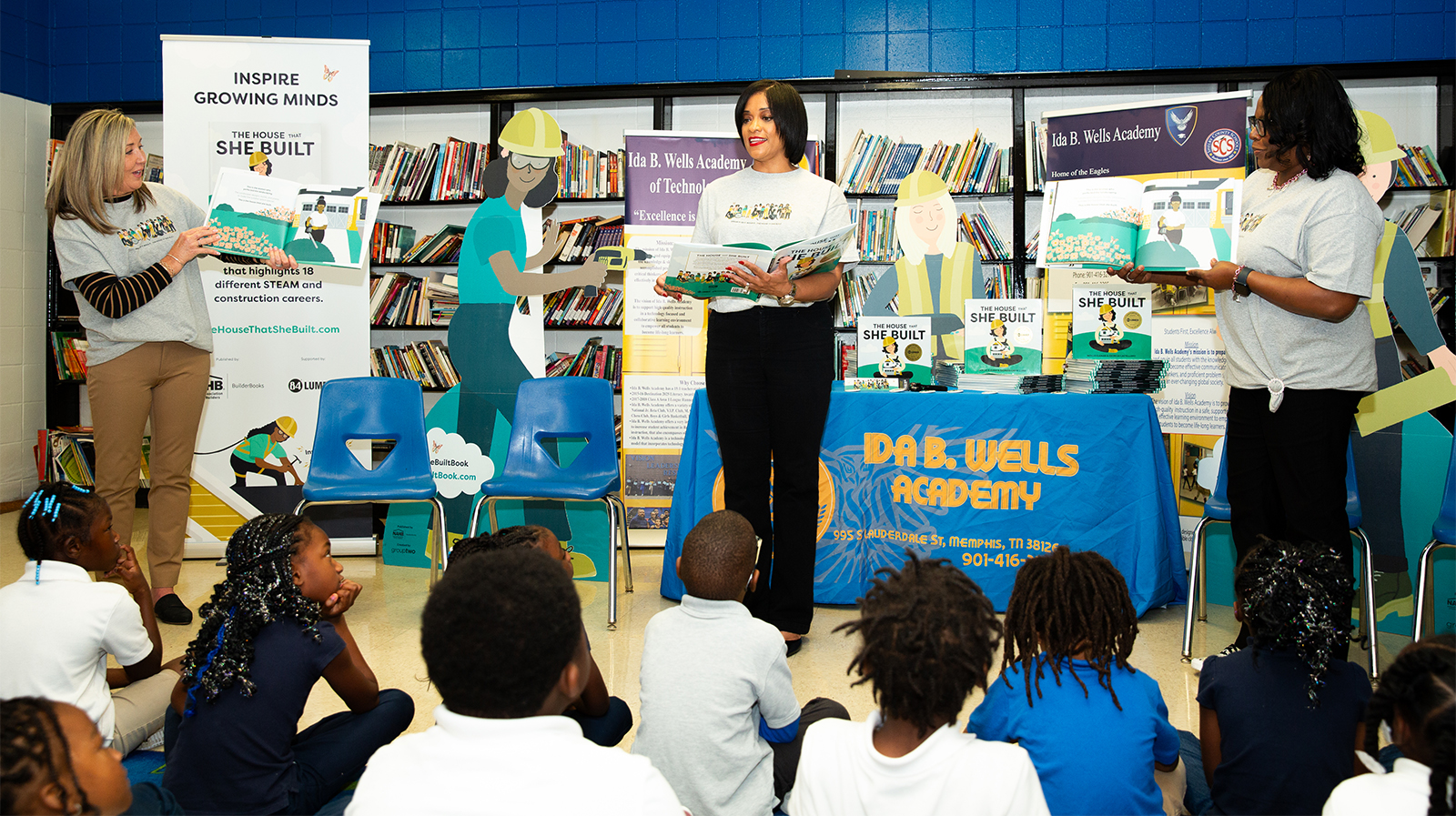 Tammie Ross reads The House That She Built to a group of elementary students