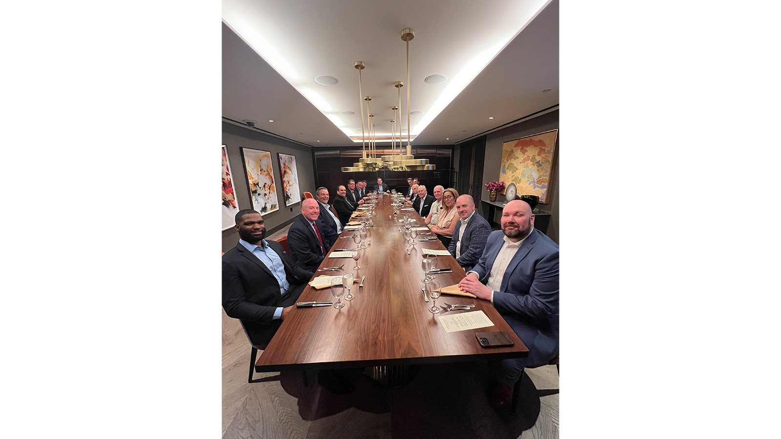 Table of 18 enjoy dinner and wine night at the 2024 New York BUILD-PAC fundraiser
