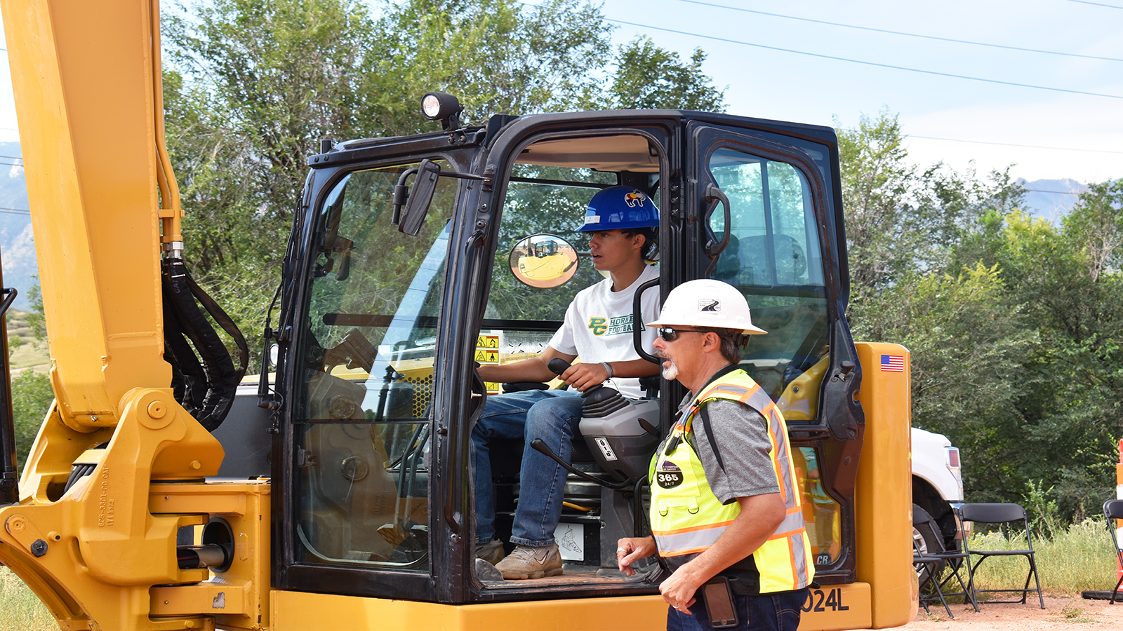 A student is guided through a project by a CICC volunteer.