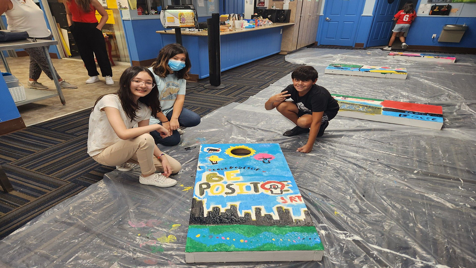 Students from the Boys & Girls Clubs of Cathedral City (Calif.) build cornhole boards.