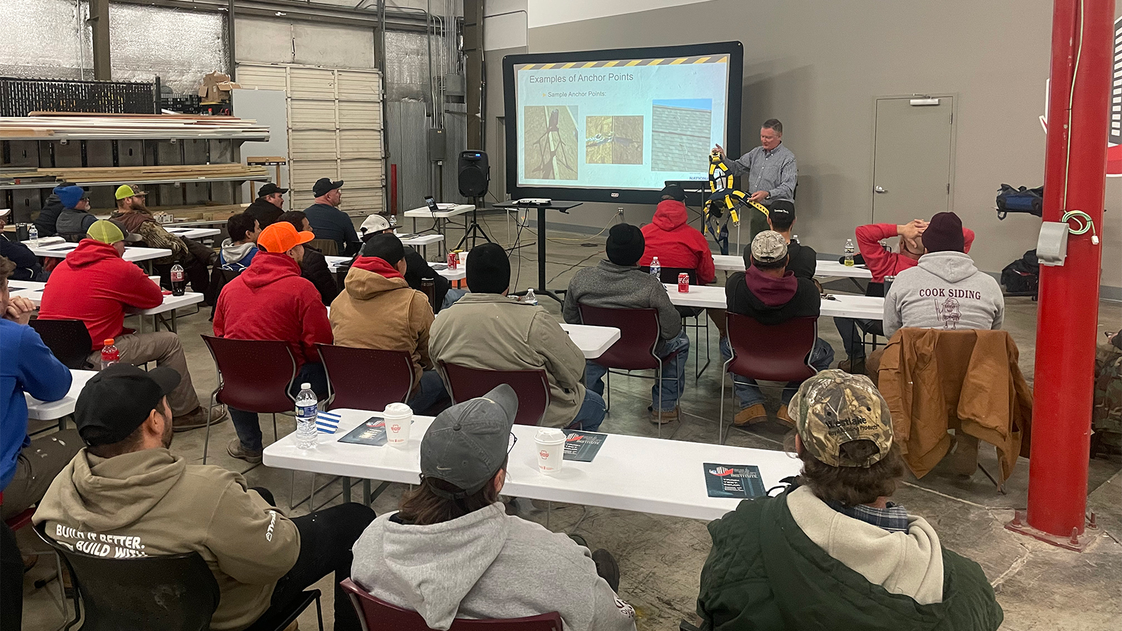 Instructor George Middleton explains harnesses and anchor points during the training