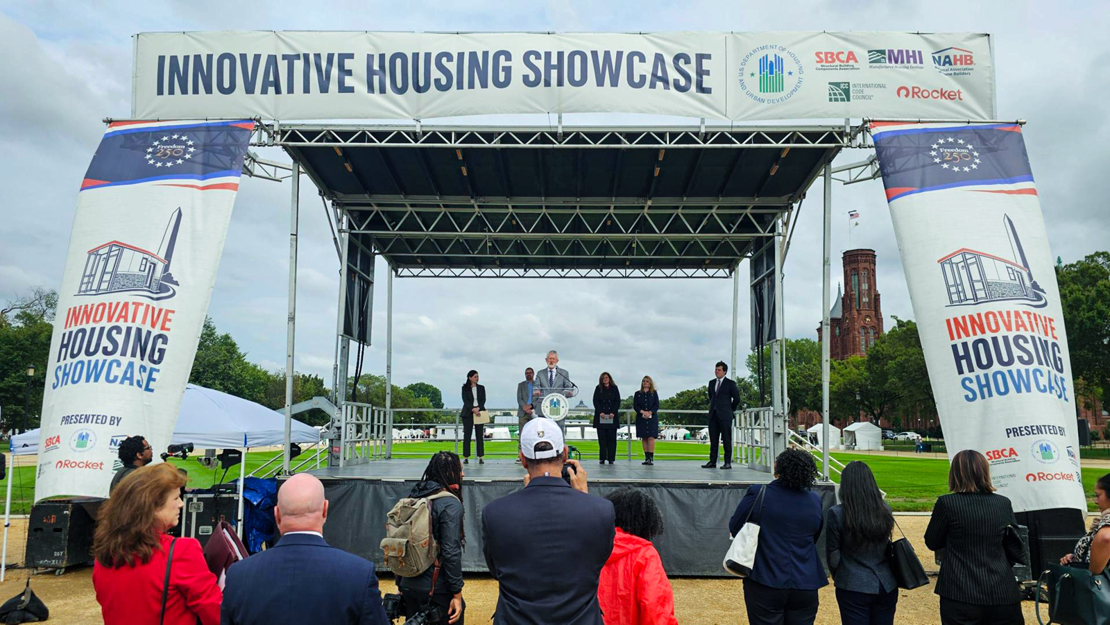 Bill Owens speaking on the stage at the Innovative Housing Showcase