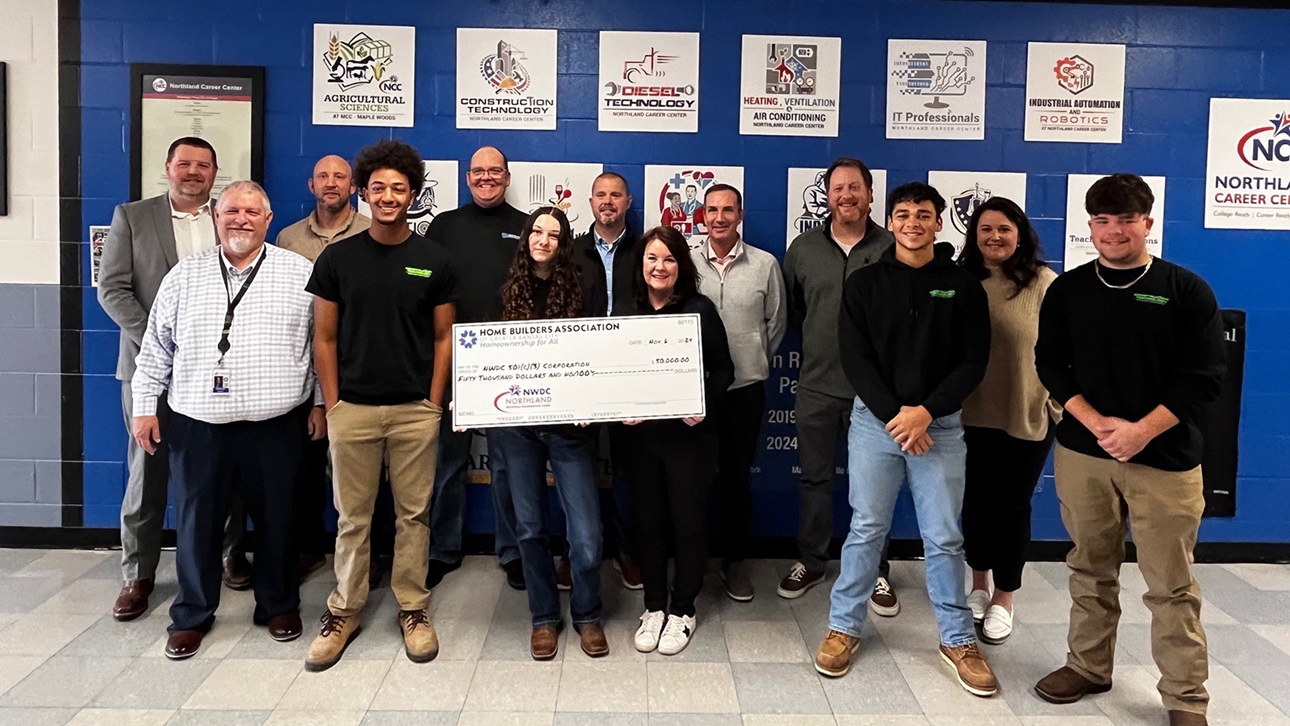 members present check to group of students and educators