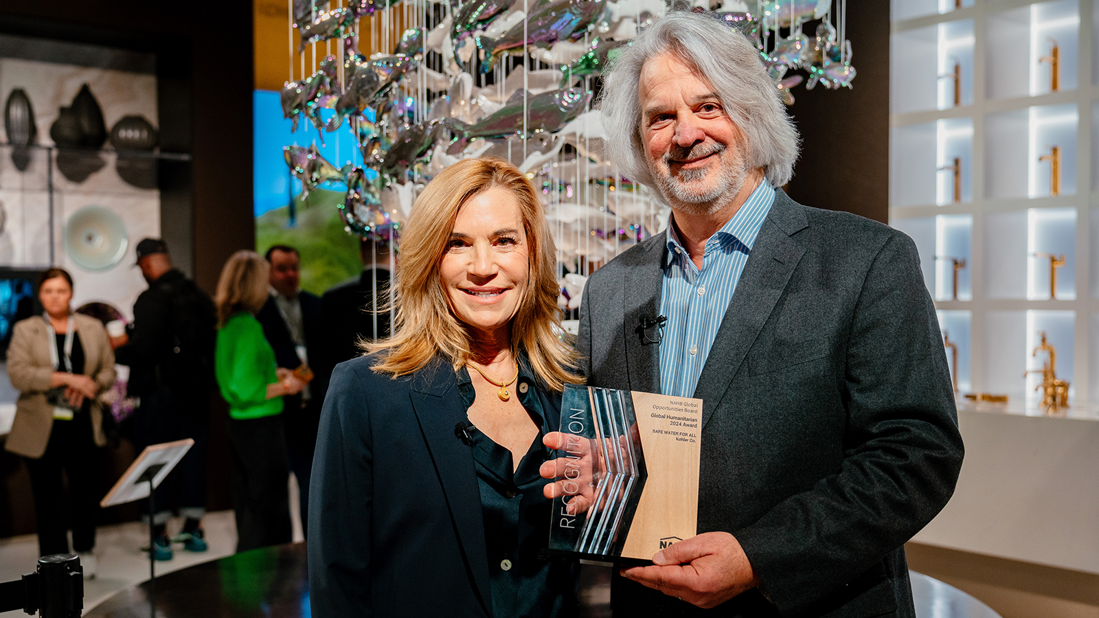 NAHB 2024 Global Opportunities Board Chair Steve Kleber presents Kohler Chief Sustainability Officer Laura Kohler with Global Humanitarian Award for Safe Water for All initiative.