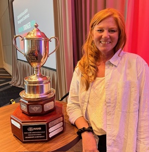 Amy Schuster accepts the 2023 Membership Cup trophy