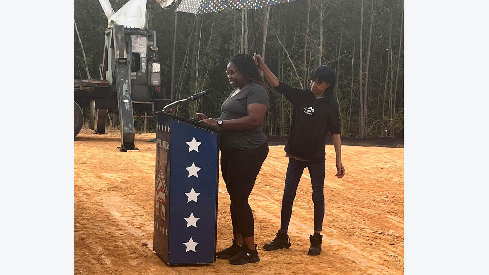 Ava Bradley at podium addresses crowd