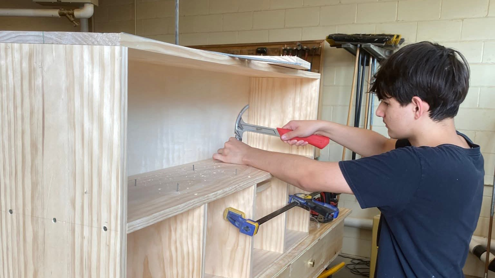 A student builds a shelf as part of local workforce development training.