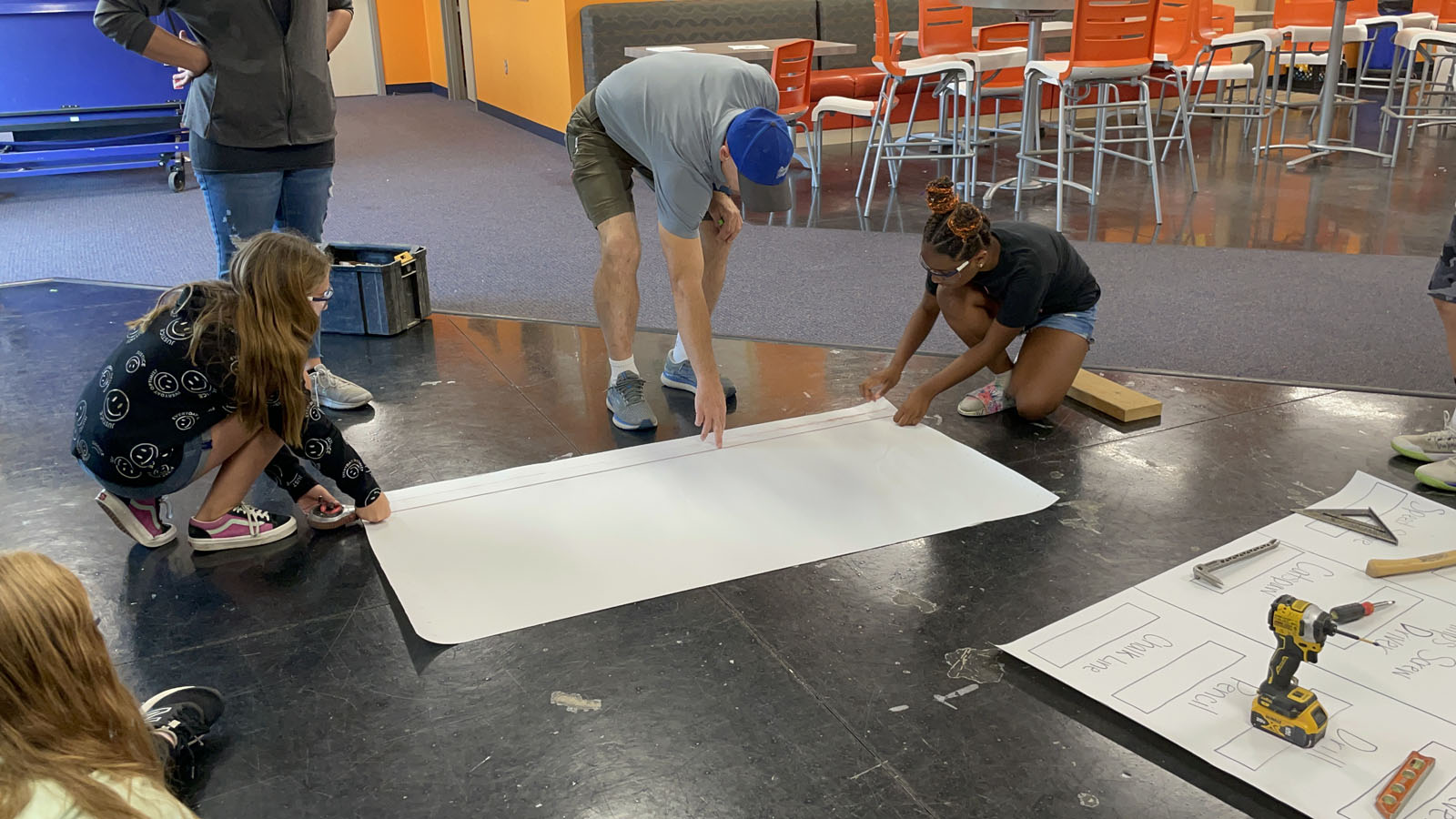 teens learn how to use a chalkline