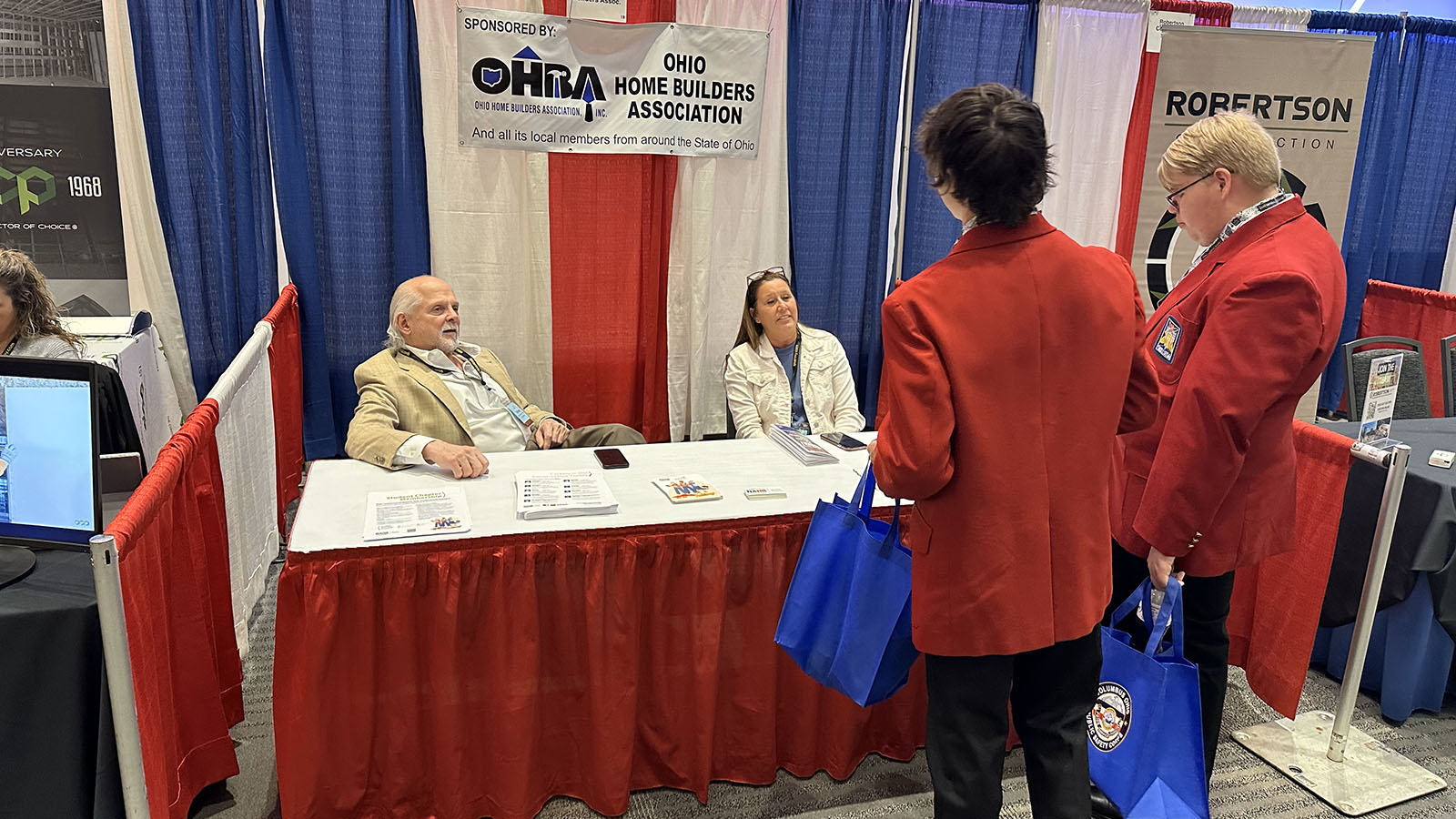 students learning about hba at booth