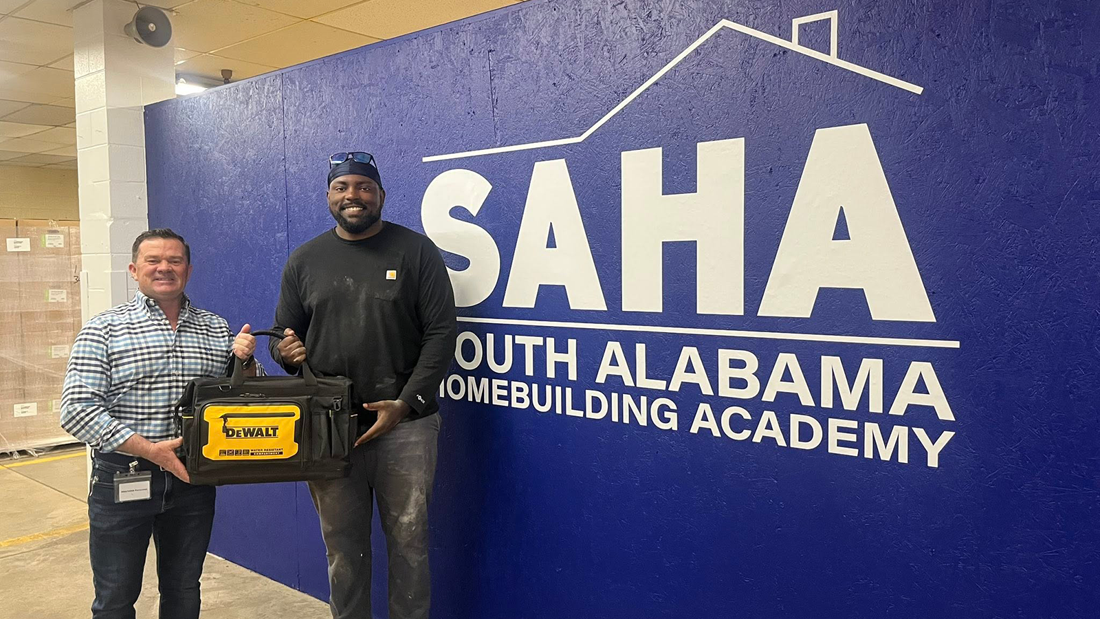 A SAHA graduate poses for a photo on graduation day.