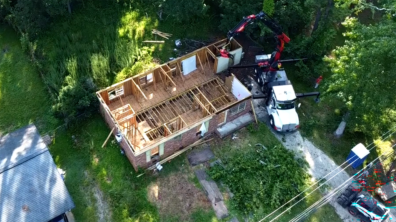A home renovation shown with the roof torn off.