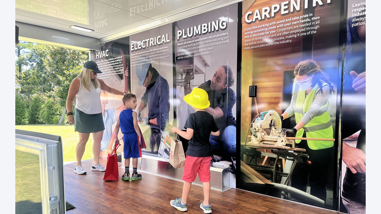 children reading about careers in construction on panels