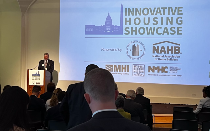 Jerry Konter on stage speaking at a meeting