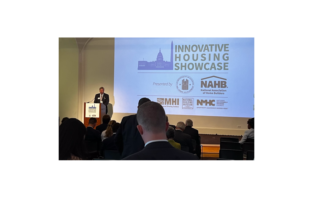 Jerry Konter on stage speaking at a meeting