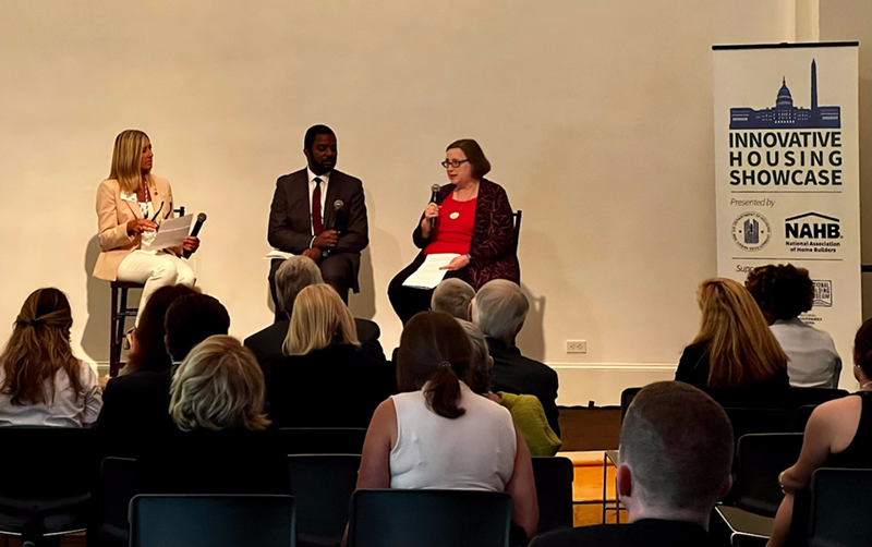 Alicia Huey moderates a panel on stage