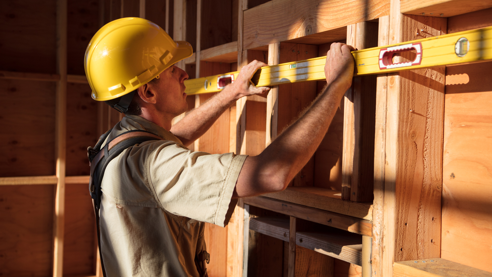 Measure built. Construction worker at Construction site measures the length of Window Opening