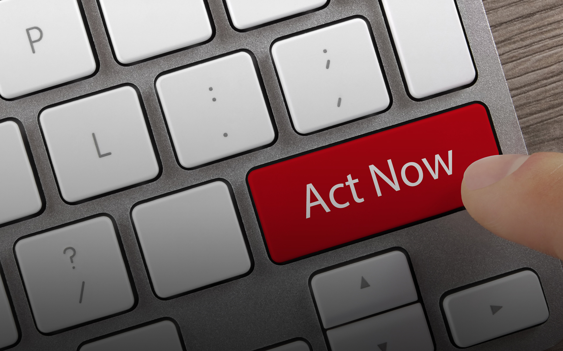 A computer keyboard with a red "Act Now" button