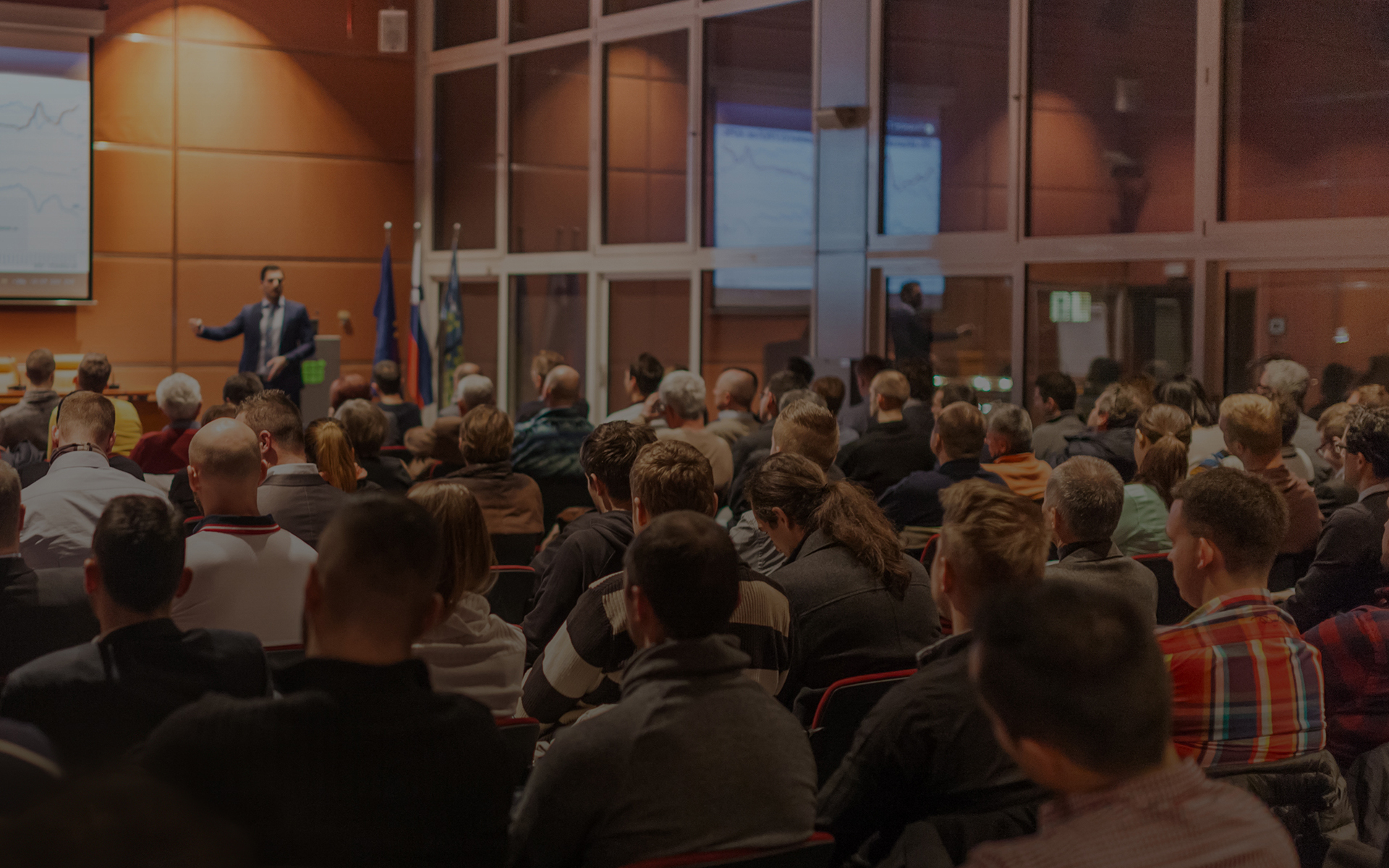 A meeting session in a large auditorium