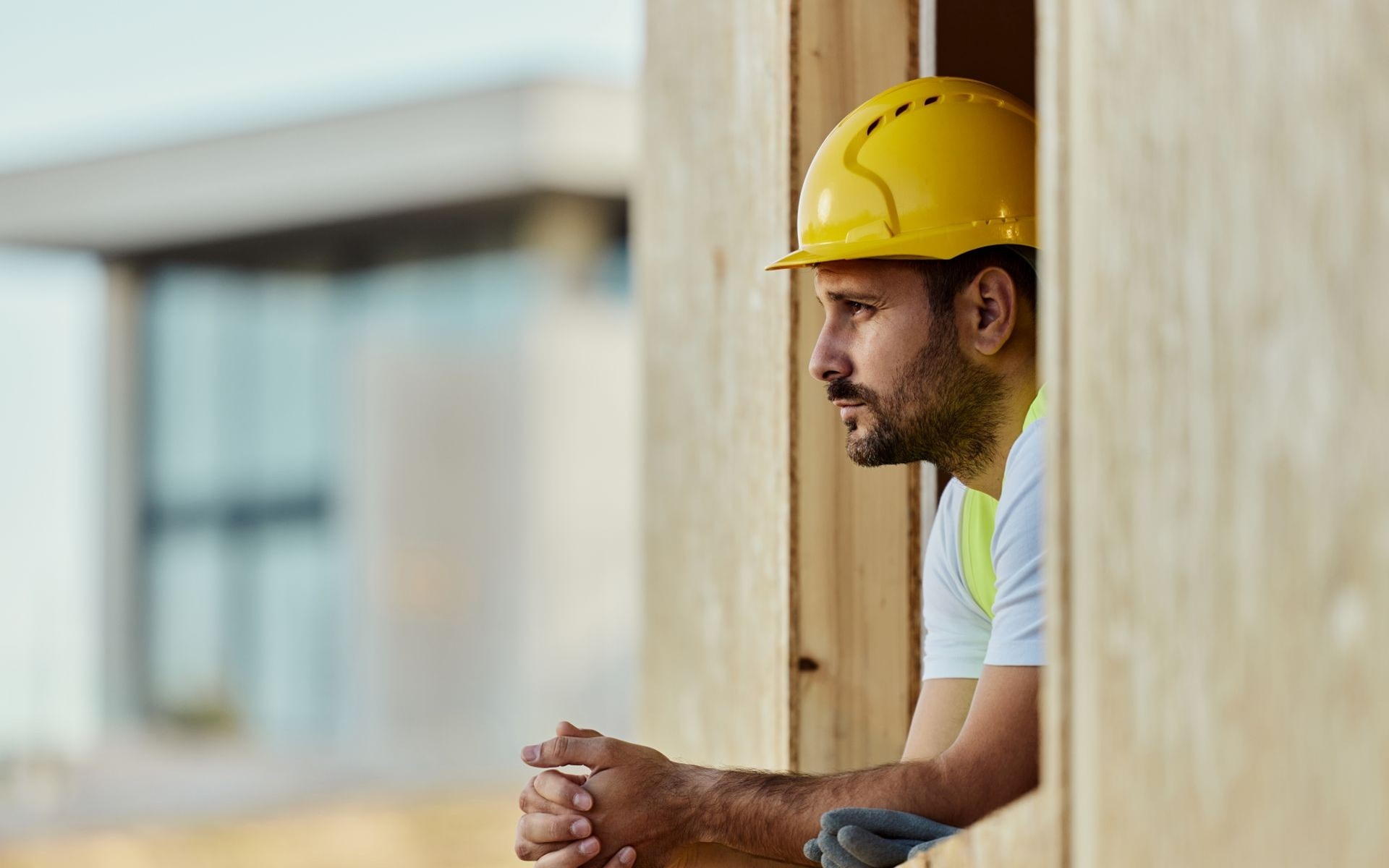 Construction worker standing inside a building under construction.