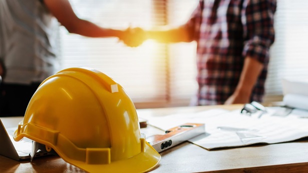 Builder and client shaking hands