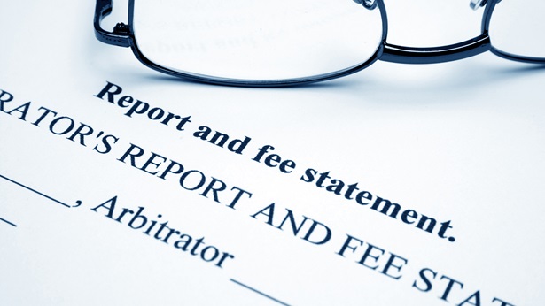 Glasses laying on document with report and fee statement title