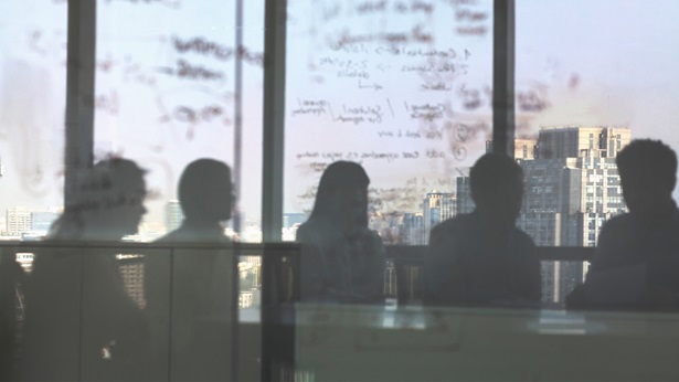 Group of silhouette people in a meeting overseeing a city