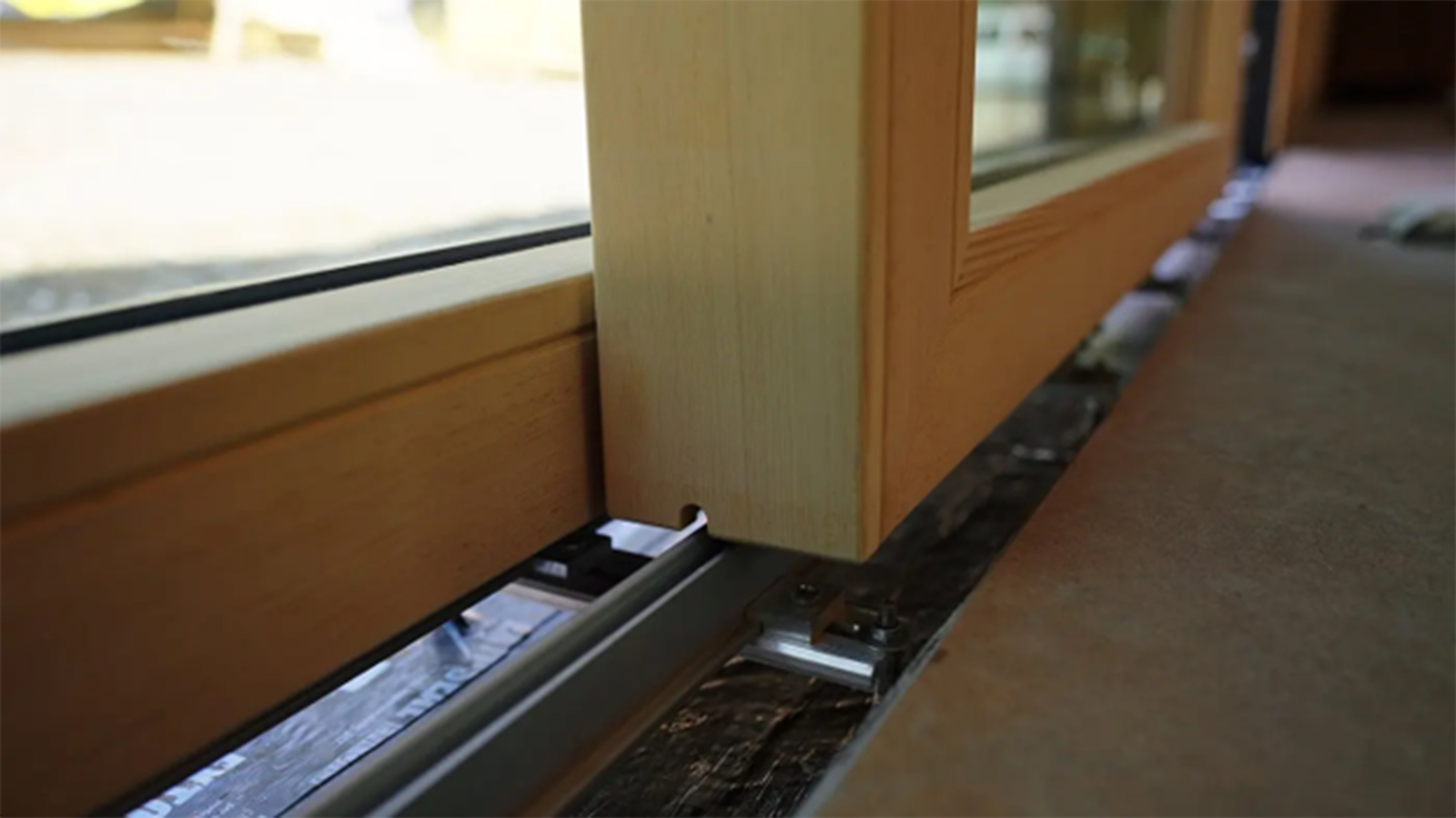 Close-up of a flush Liftslide door track and frame installation.