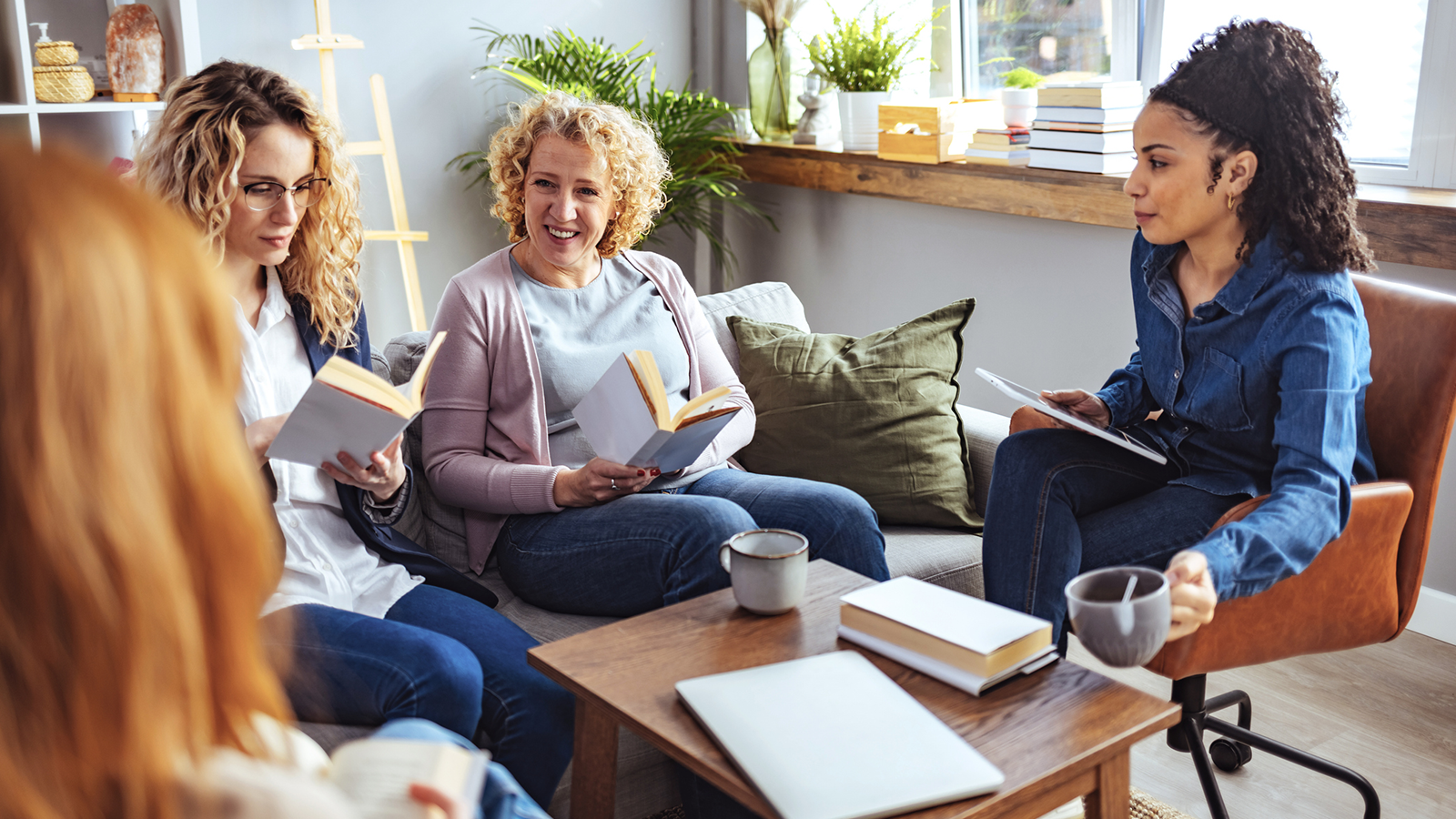 Women discussing a book in a book club meeting.