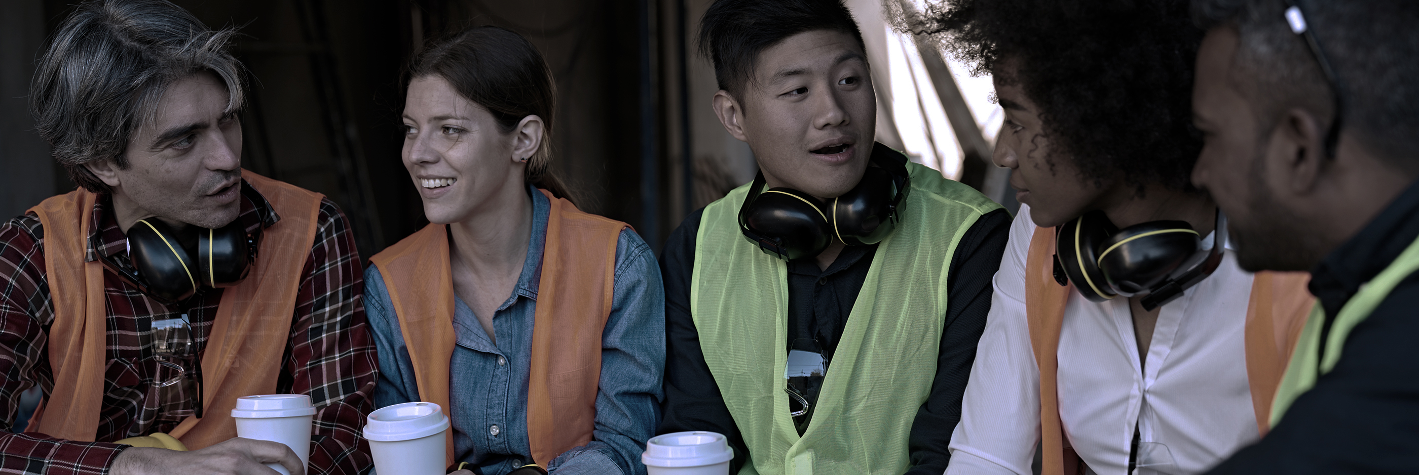 A group of young people talking at the construction site